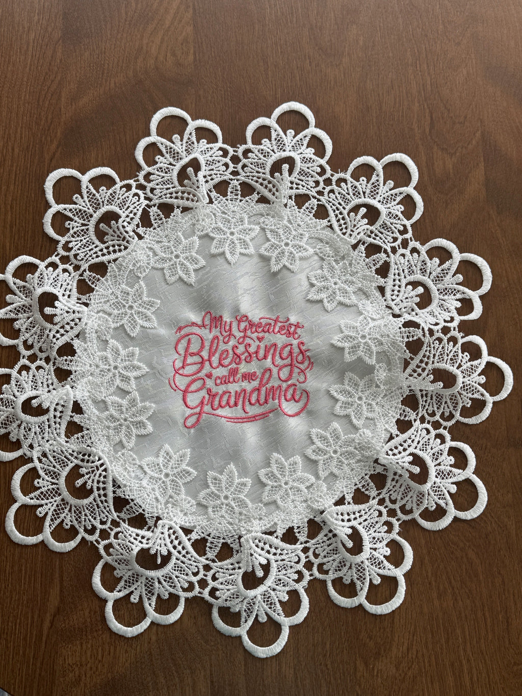 'My Greatest Blessings Call Me Grandma' machine embroidered 16" white doily