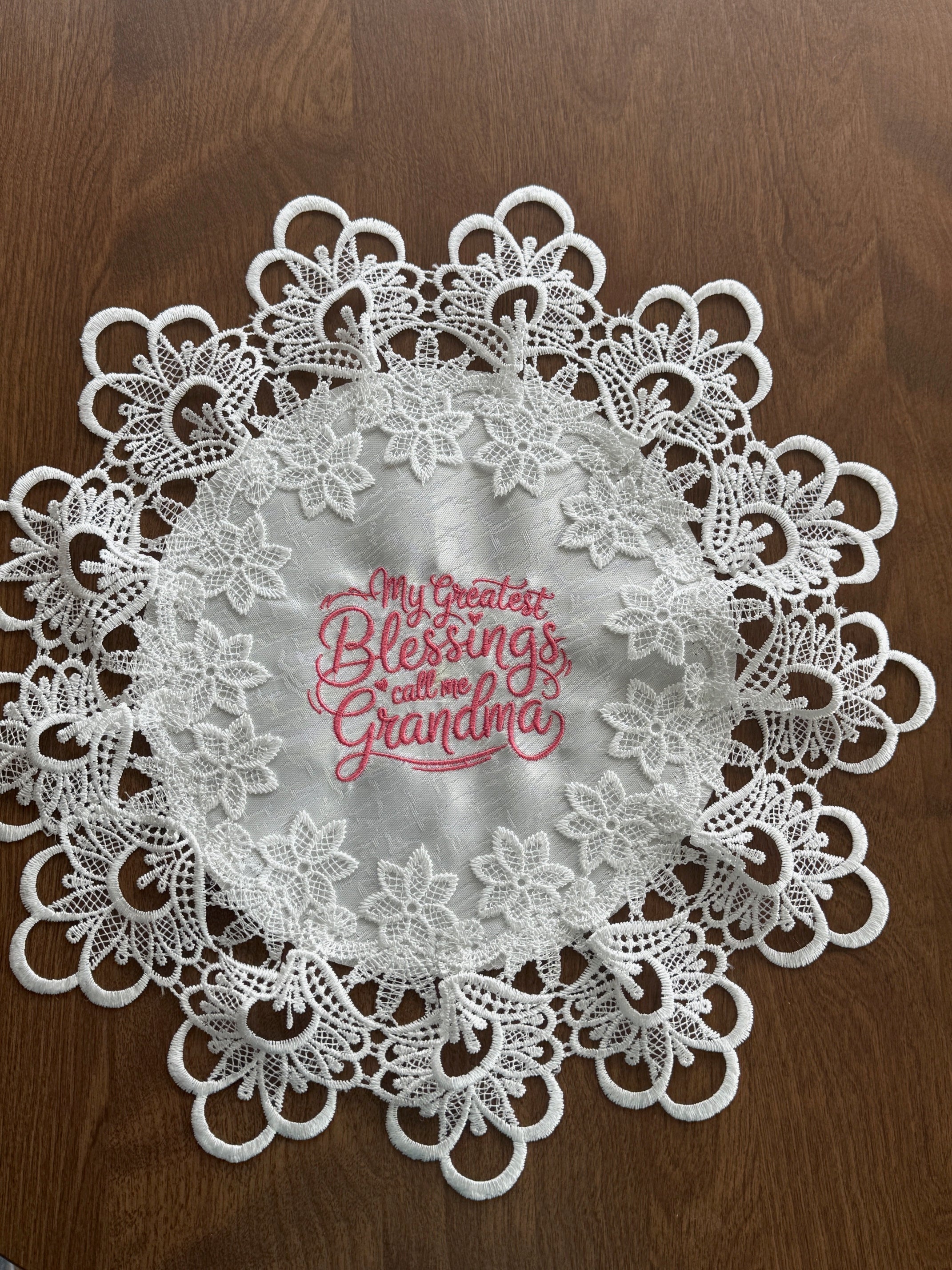 'My Greatest Blessings Call Me Grandma' machine embroidered 16" white doily