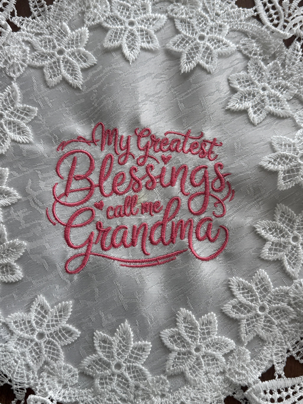 'My Greatest Blessings Call Me Grandma' machine embroidered 16" white doily