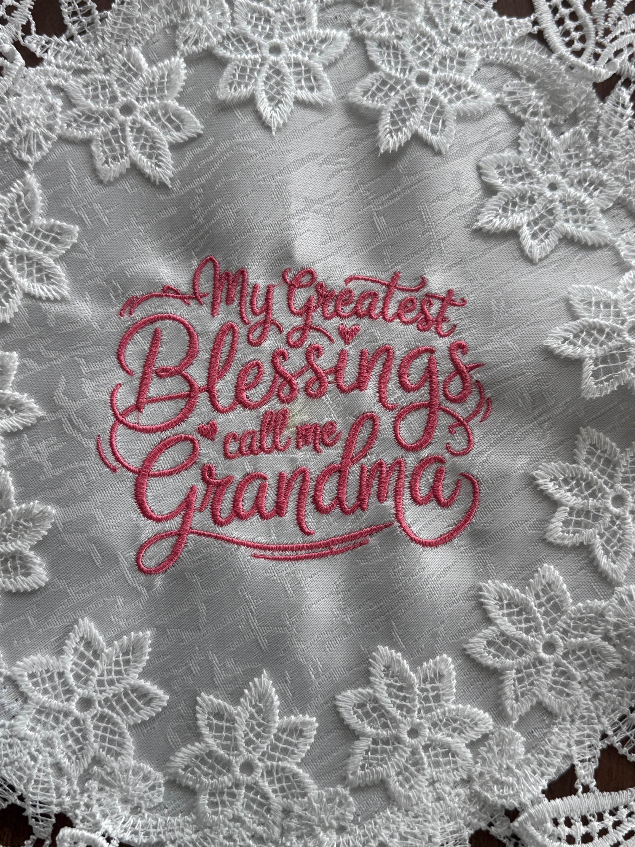 'My Greatest Blessings Call Me Grandma' machine embroidered 16" white doily