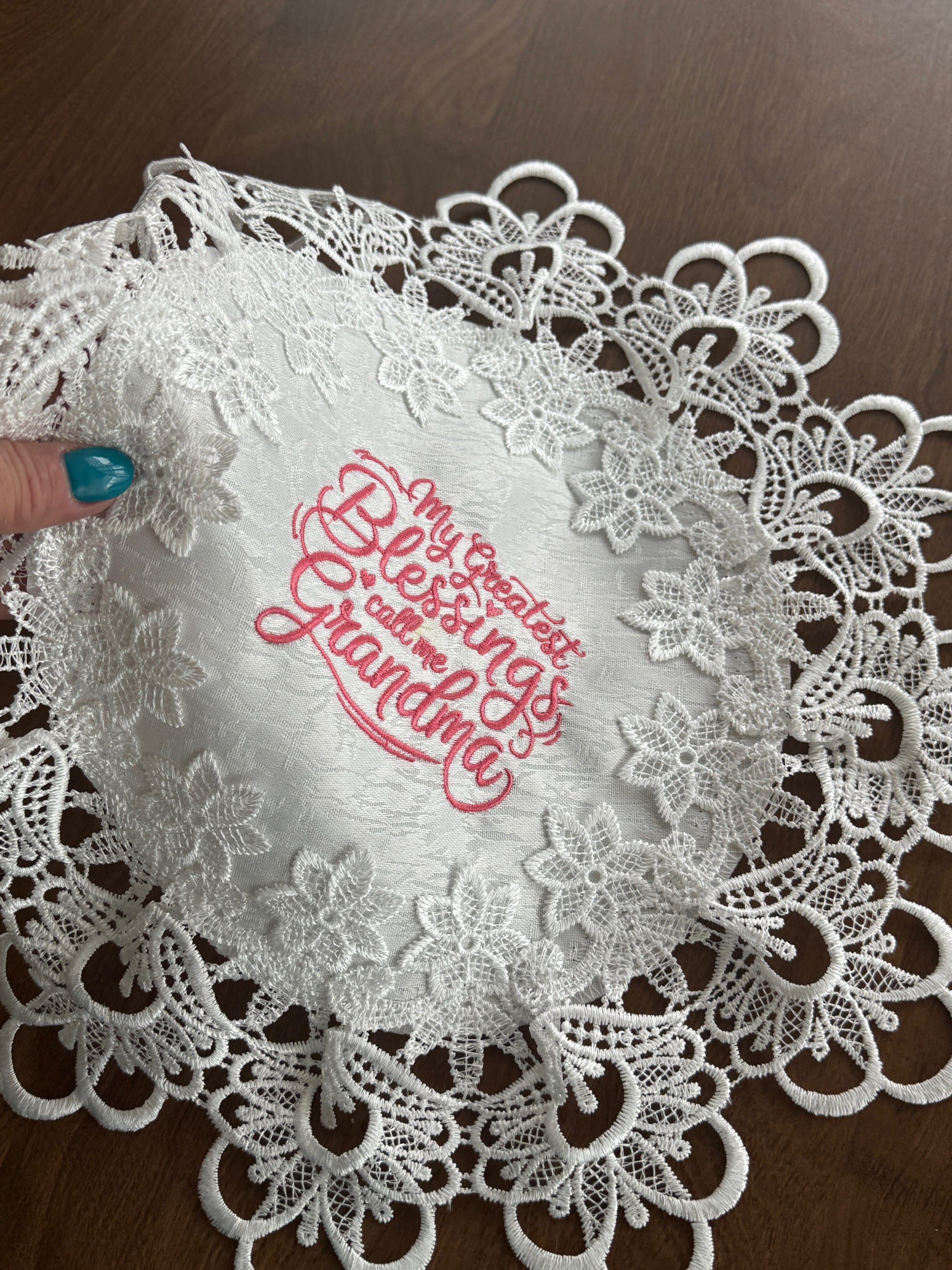 'My Greatest Blessings Call Me Grandma' machine embroidered 16" white doily