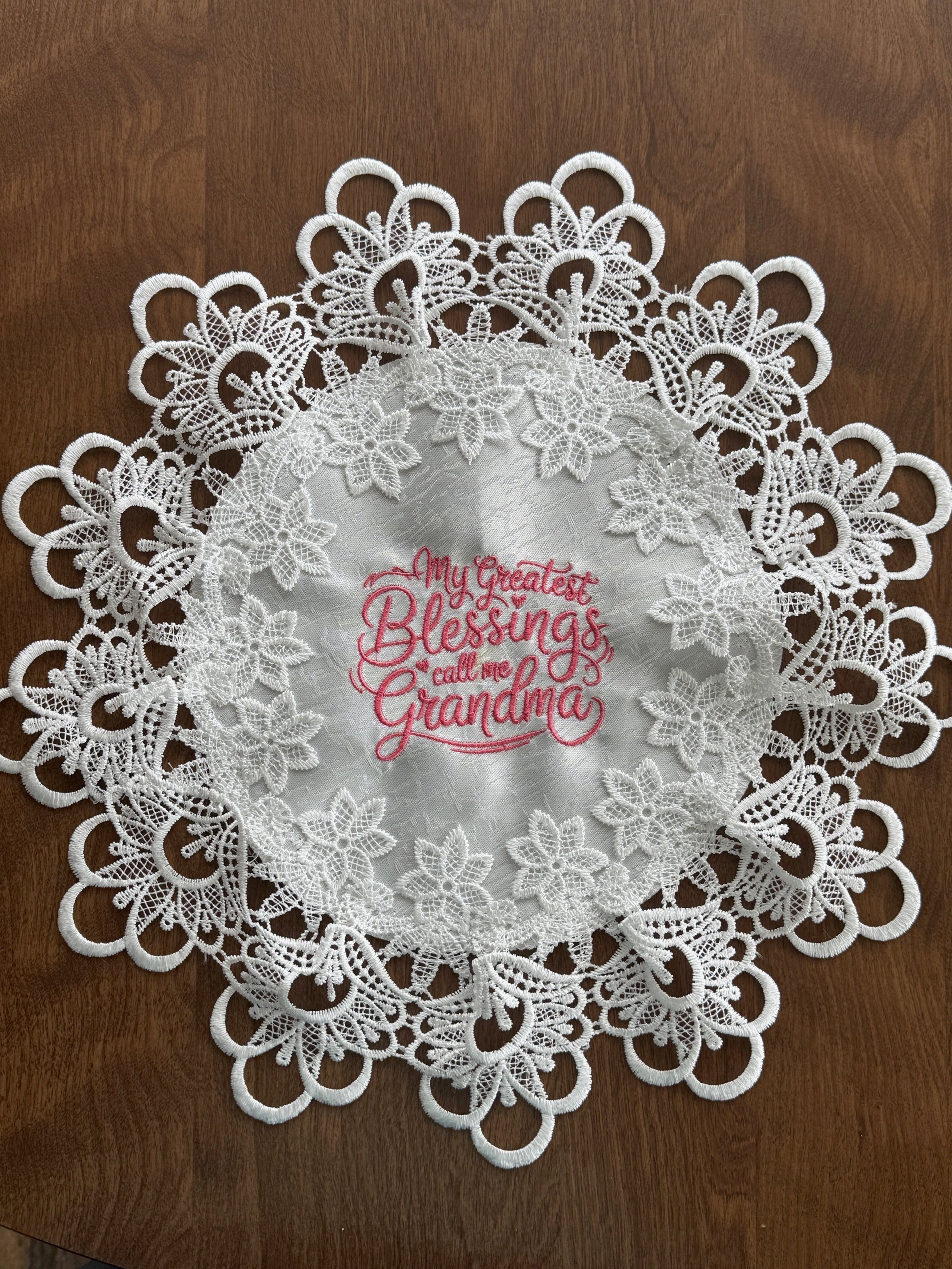 'My Greatest Blessings Call Me Grandma' machine embroidered 16" white doily